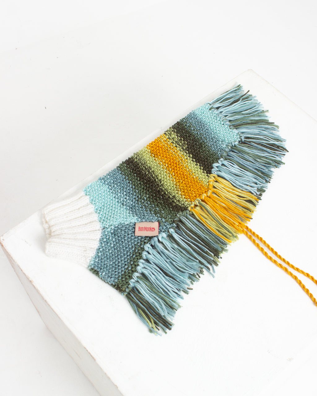 multicolor stripe dog poncho with fringes on a white background